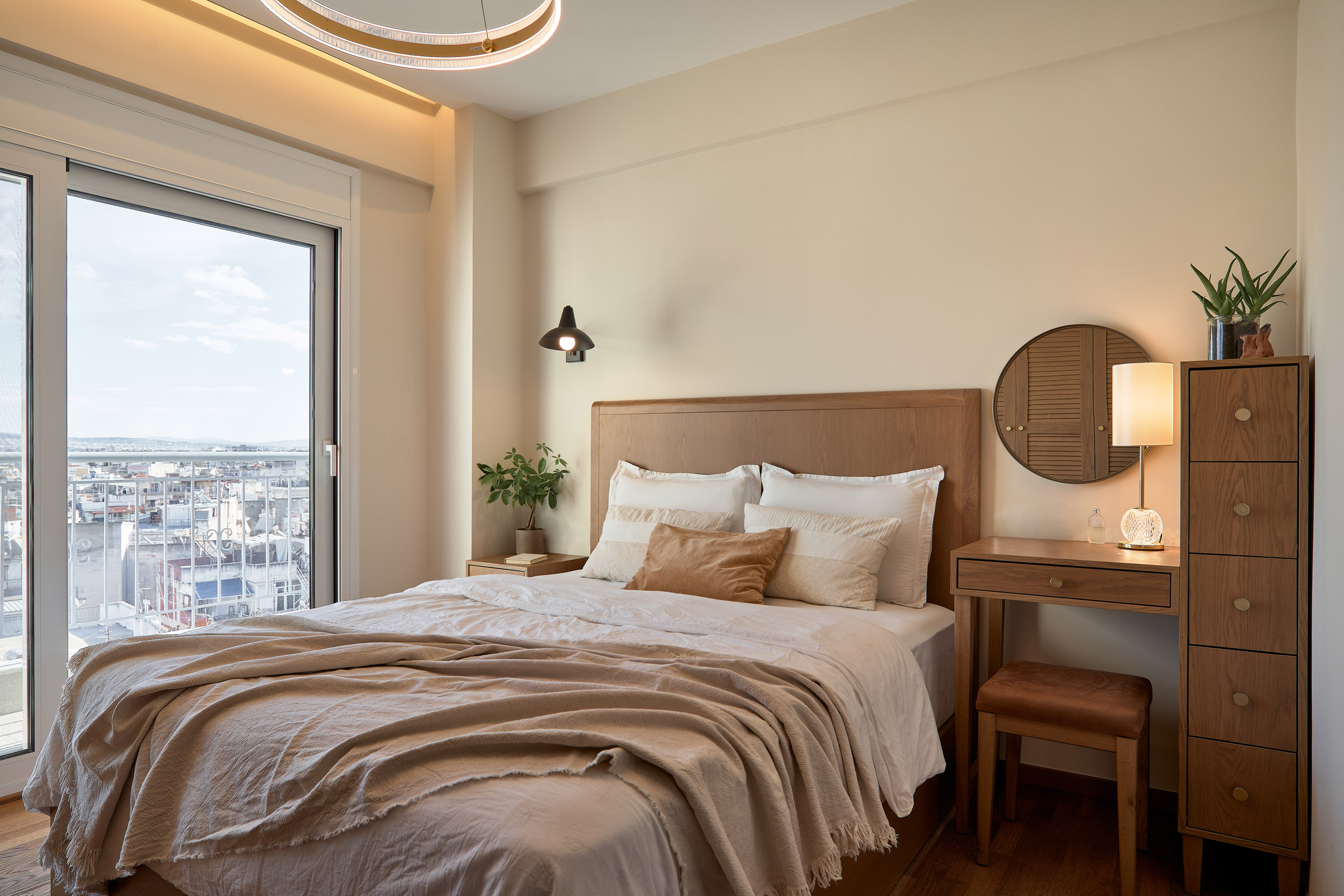 Bedroom of a renovated apartment in Thessaloniki with large openings and city view 