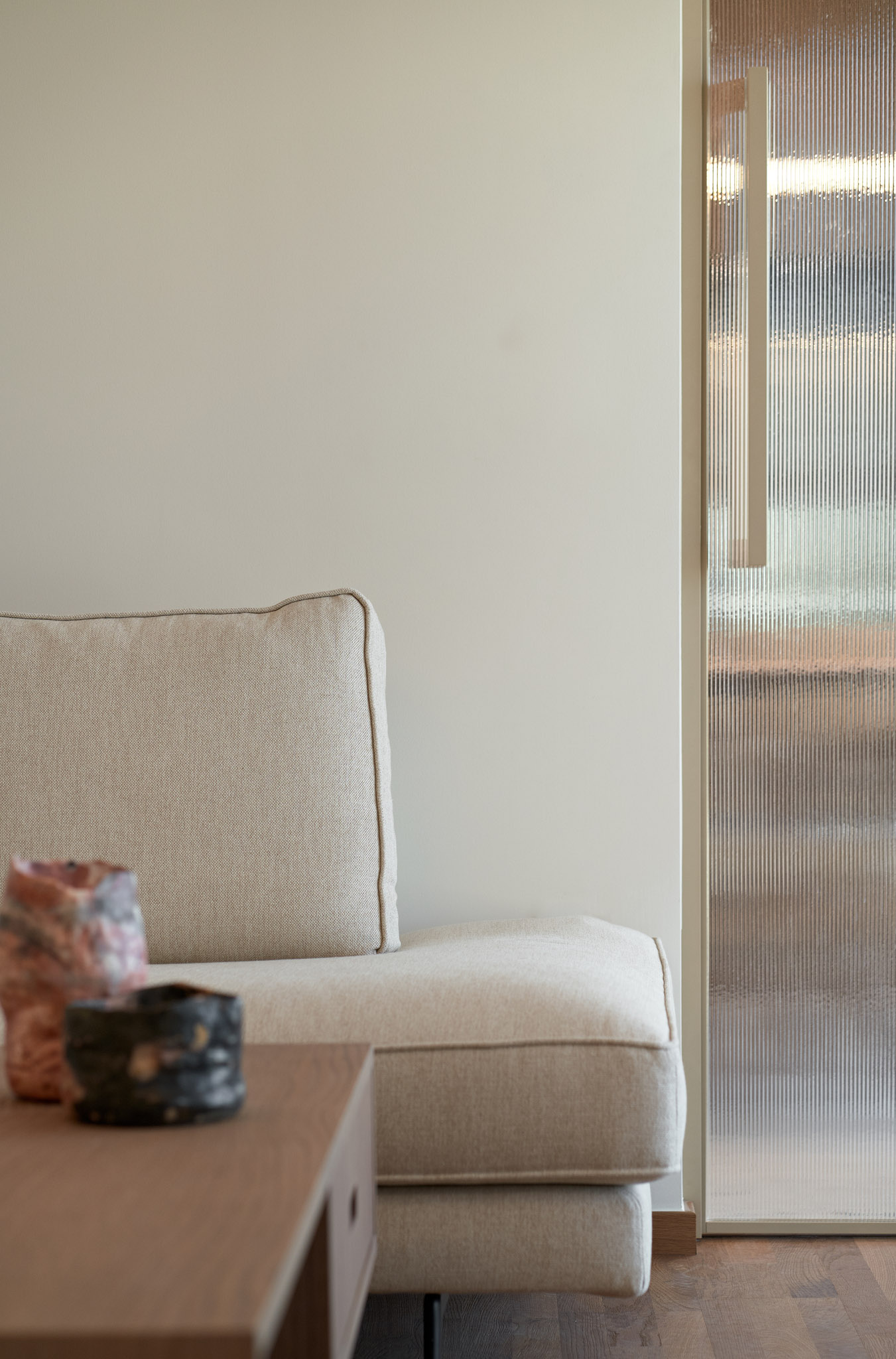 Living room of a renovated apartment in Thessaloniki - sofa glass door detail