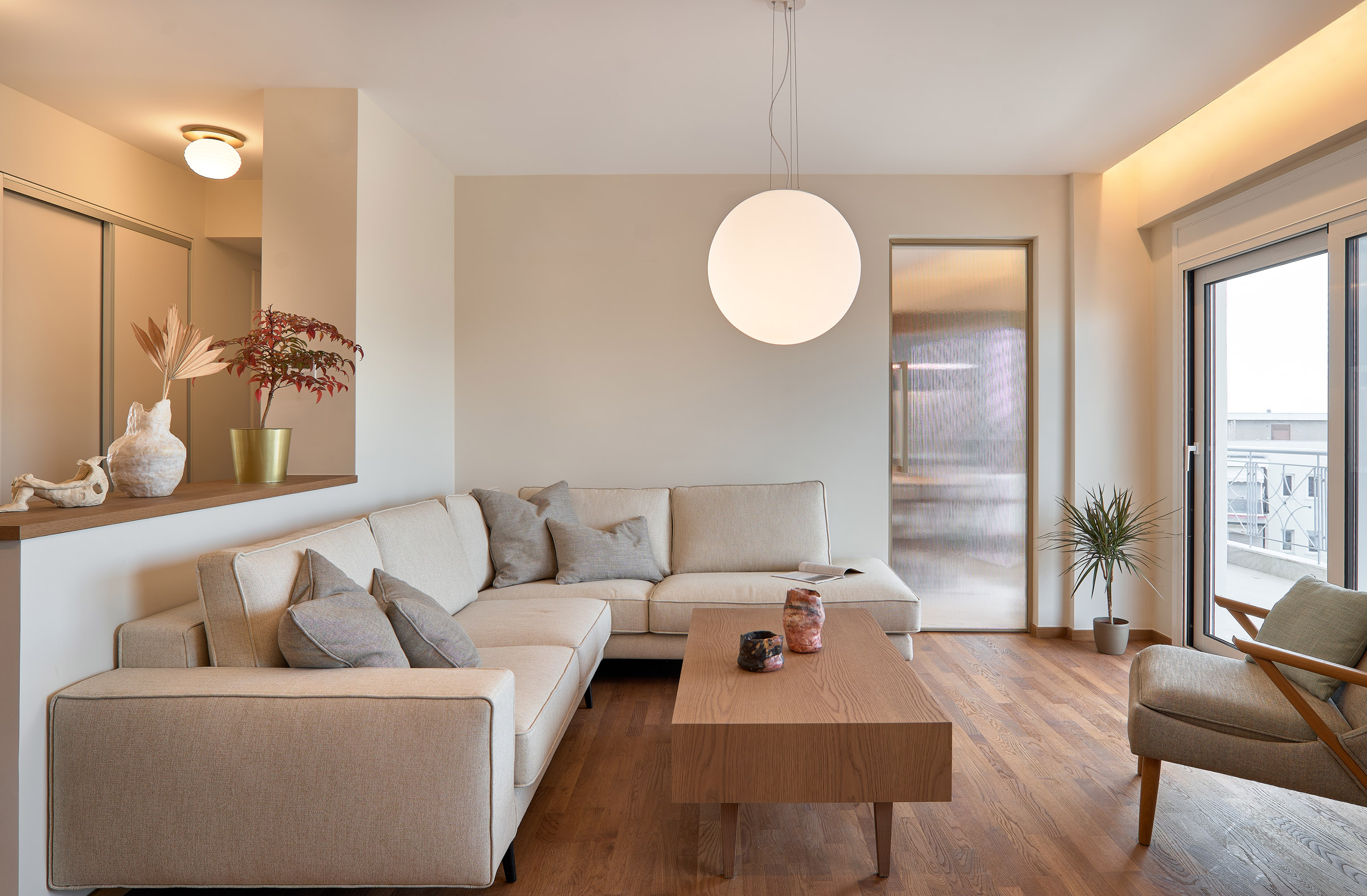 Living room of a renovated apartment in Thessaloniki with large openings